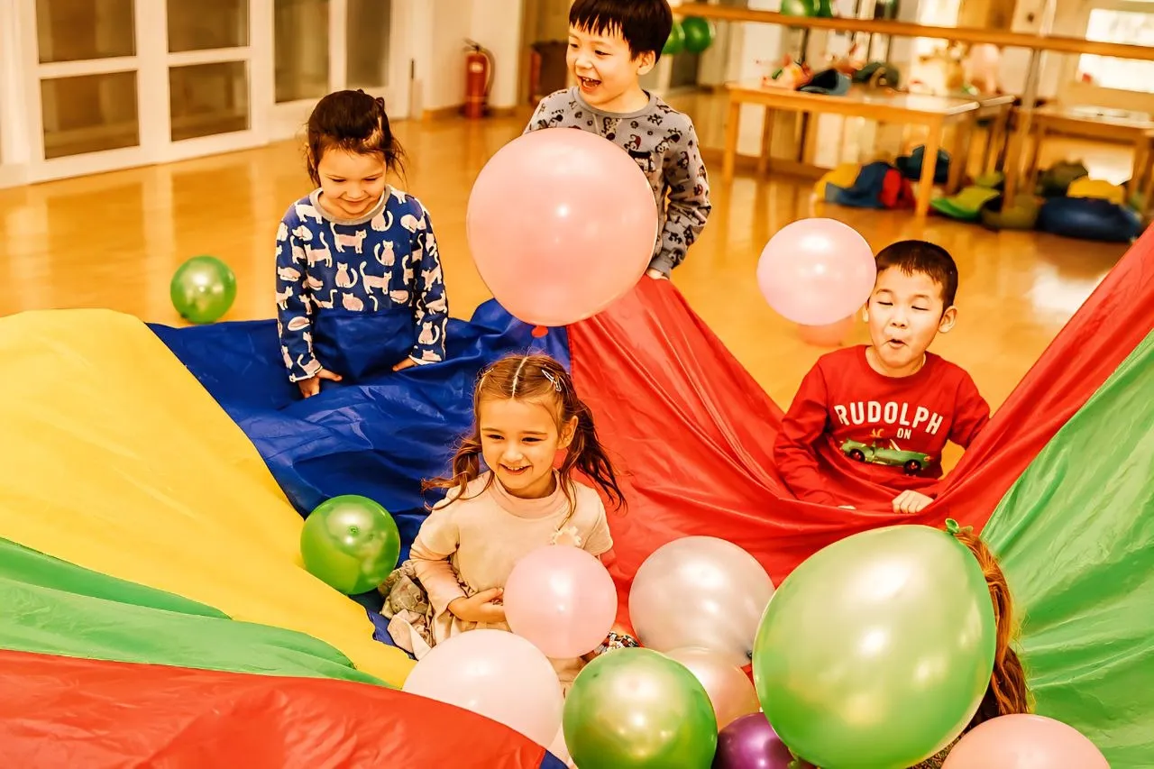 Happy kids celebrating birthday with confetti and balloons